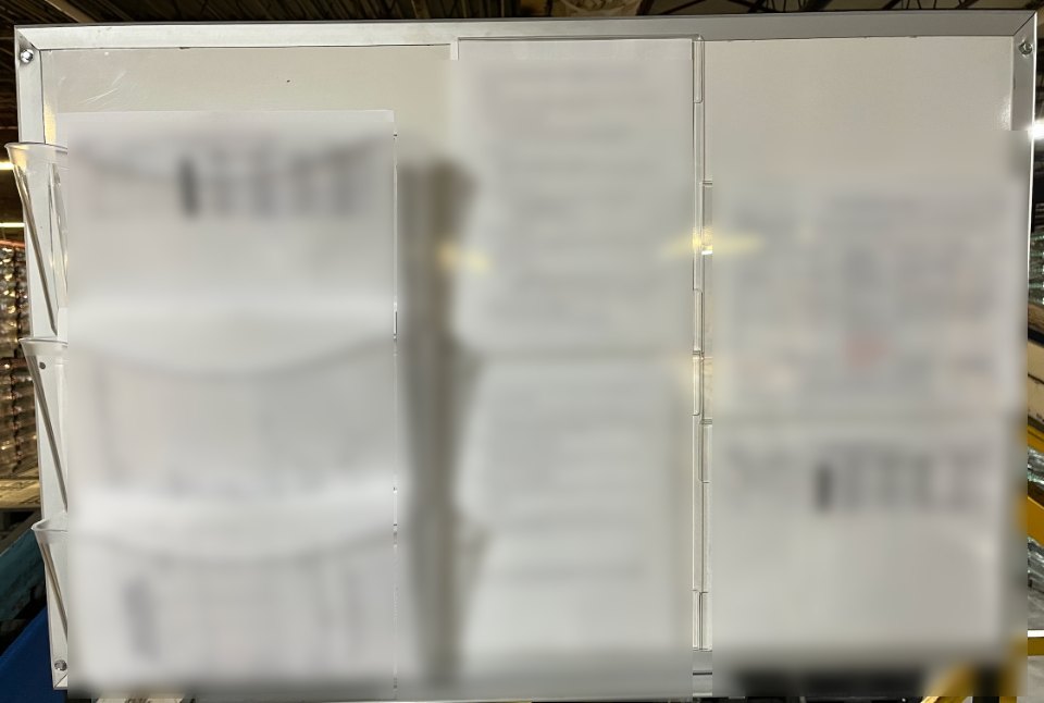 Standards, checklists and escalation procedures posted on a board at the line